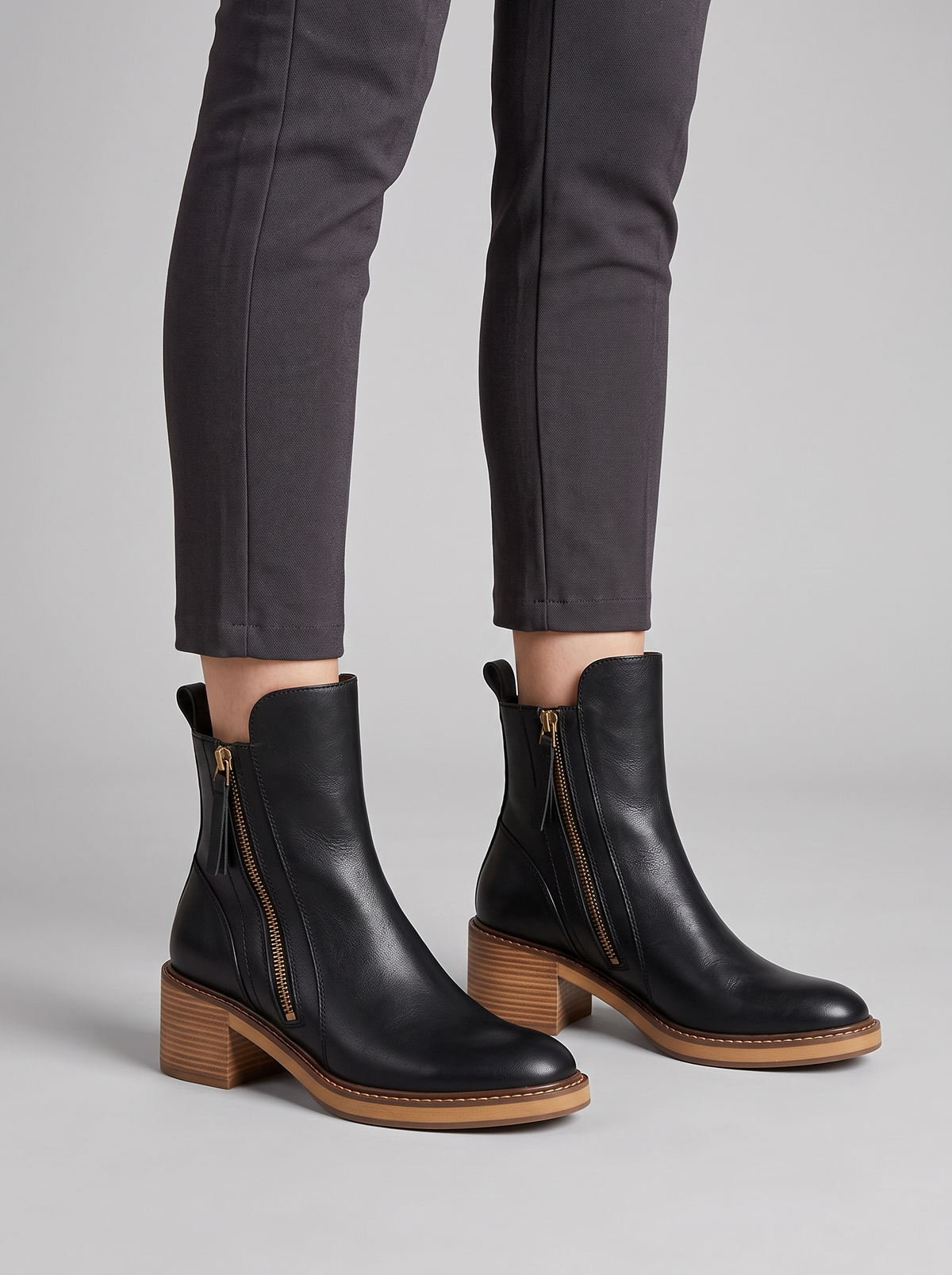 Erica black leather block heel ankle boots worn with slim dark trousers